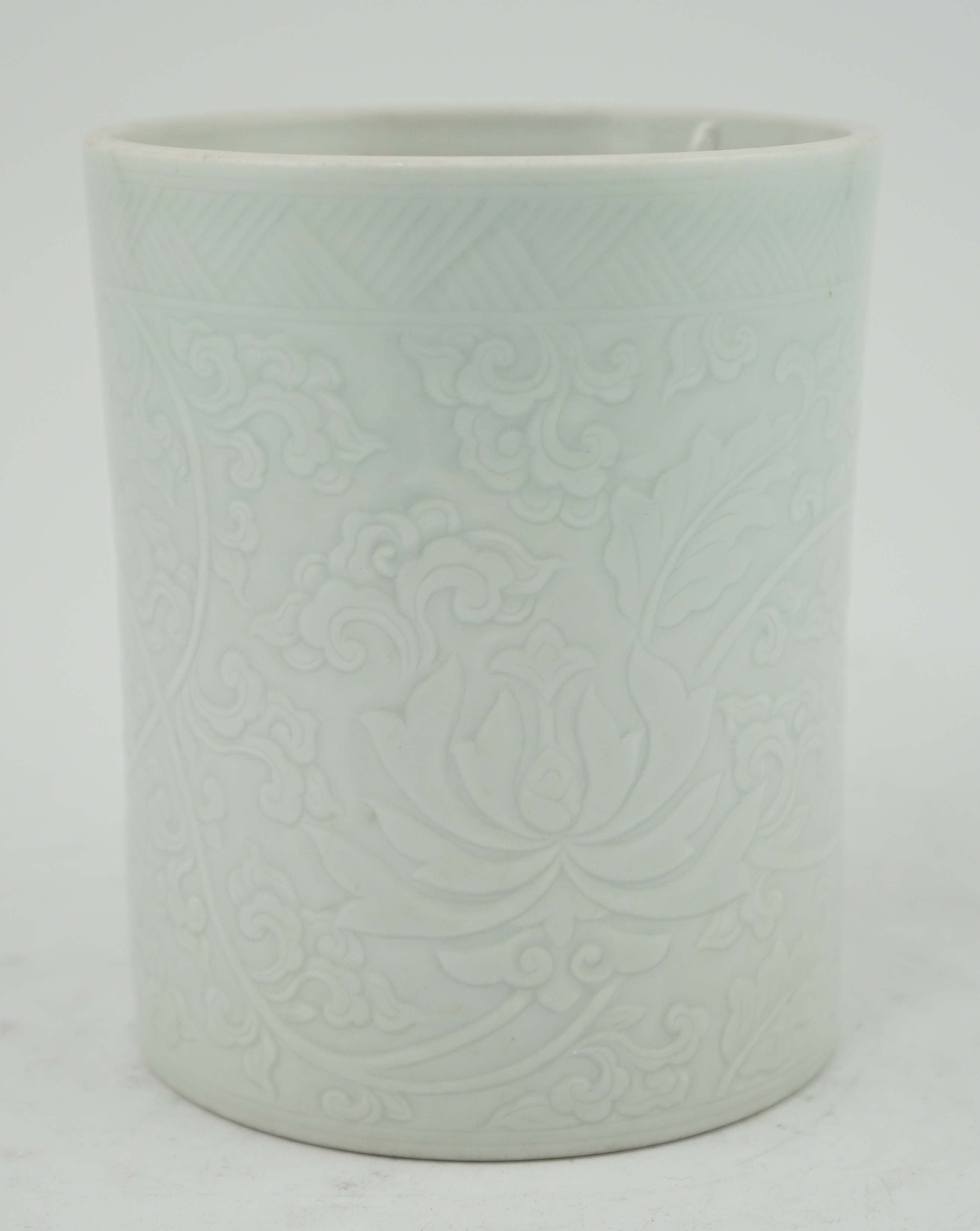 A Chinese celadon glazed brush pot, Kangxi style, 15.5cm high. Condition - good